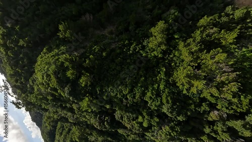 Bird's eye view of flying above beautiful sea in Okinawa in the afternoon