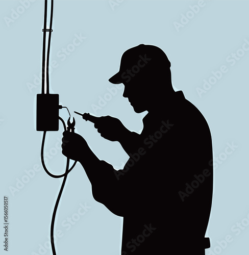 Silhouette of a male electrician working on wiring with tools.