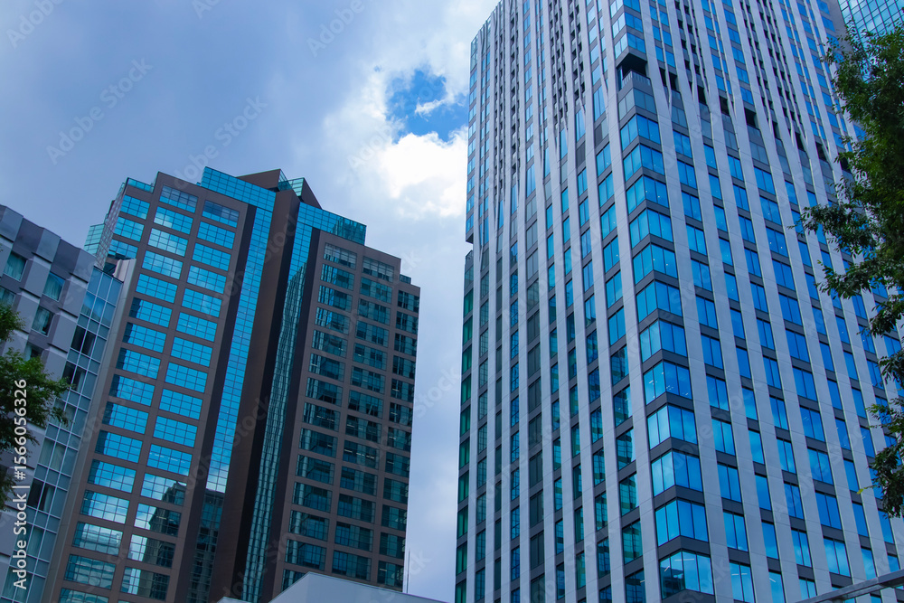 Naklejka premium A cityscape of moving cloud reflecting the office building at the business town