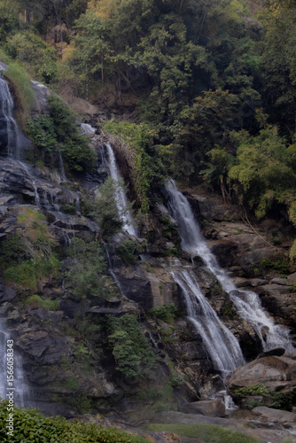 Siriphum Waterfall in Doi Inthanon, Chiang Mai, Thailand – tall mountain waterfall flowing through dense tropical forest in a serene natural setting.
