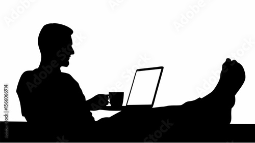 Silhouette of a man working on a laptop with his feet up and holding a cup of coffee in his hand