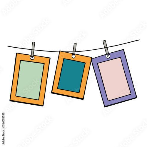 Photo frames hanging on a rope, clipped with clothespins, creating a charming, rustic display of memories and moments in a cozy, decorative style.
