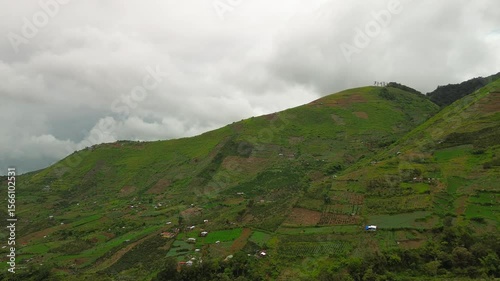 Wallpaper Mural Mount Apo’s foothills unfold as a vivid quilt of vegetable plots and scattered huts, their green-brown terraces fading into low, drifting cloud banks along the horizon. Torontodigital.ca
