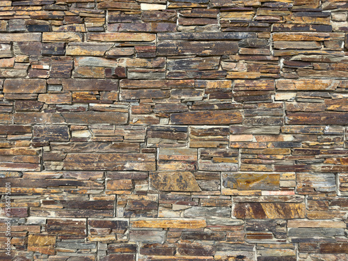 Rustic Elegance: Close-Up of Textured Stone Wall in Earthy Tones