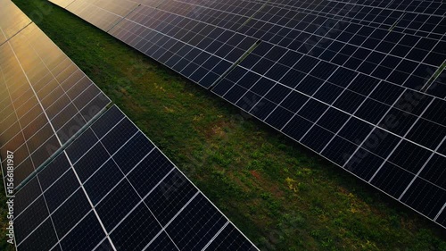 Aerial view of a solar farm generating solar energy.Solar panels park generating green energy electric at sunset.Green energy reduce carbon emissions and makes earth cleaner and more ecological.	
