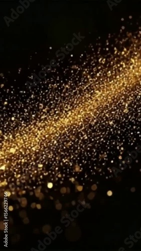 A dark background is overlaid with a sparkling stream of golden particles, creating a luxurious and elegant visual effect reminiscent of glittering dust or cosmic phenomena.