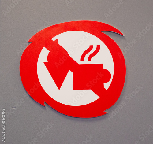 No food or drink allowed sign. Red Circle Warning Symbol. Crossed-out drink cup and ice cream cone. Eating and drinking not permitted in the area. Modern stylized graphic on gray wall background.