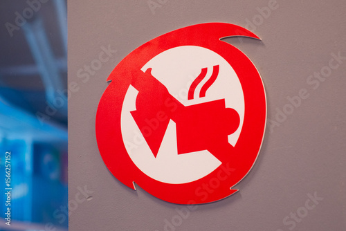 No food or drink allowed sign. Red Circle Warning Symbol. Crossed-out drink cup and ice cream cone. Eating and drinking not permitted in the area. Modern stylized graphic on gray wall background.