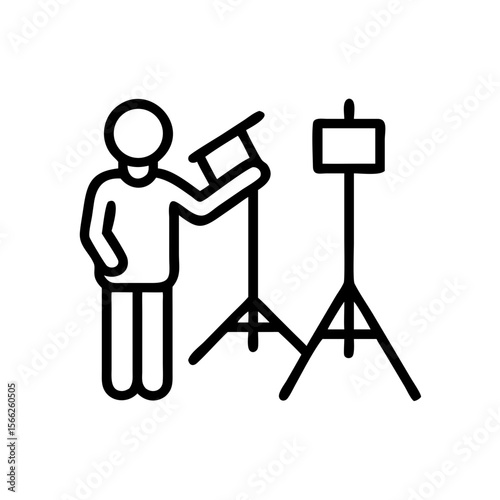 Stage technician adjusting equipment in studio setting  