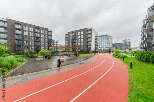 Modern Residential Apartment Complex with Jogging Path and Green Outdoor Area