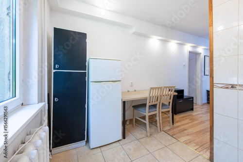 Compact Apartment Interior Featuring Kitchenette and Natural Lighting