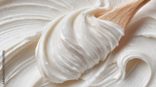 Silky White Moisturizer Application, a close-up view of a creamy moisturizer being effortlessly spread with a spatula, highlighting its smooth texture and soothing touch.