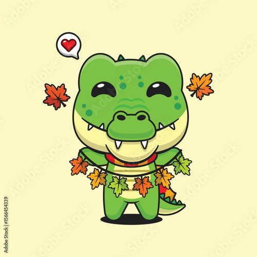 Cute crocodile holding autumn leaf decoration in autumn day cartoon vector illustration