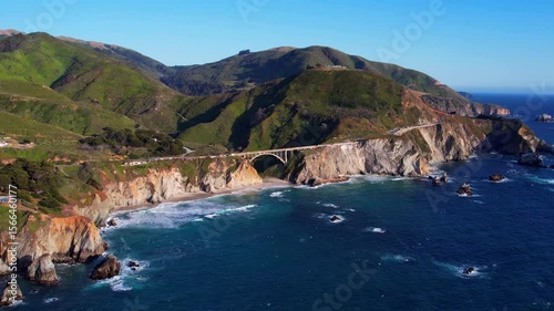 Cinematic aerial drone footage of Bixby Creek Bridge along the Pacific Coast Highway in Big Sur, California. Captured in 4K resolution during golden hour, the iconic bridge with ocean cliffs USA
