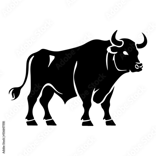 A powerful bull in silhouette standing with impressive horns and muscular build