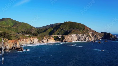 Cinematic aerial drone footage of Bixby Creek Bridge along the Pacific Coast Highway in Big Sur, California. Captured in 4K resolution during golden hour, the iconic bridge with ocean cliffs USA