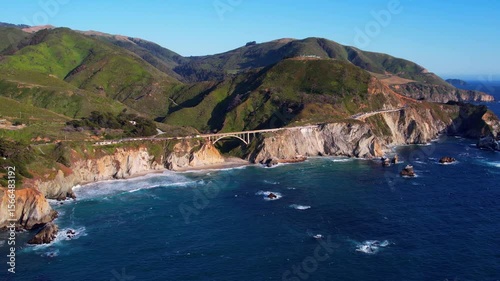 Cinematic aerial drone footage of Bixby Creek Bridge along the Pacific Coast Highway in Big Sur, California. Captured in 4K resolution during golden hour, the iconic bridge with ocean cliffs USA