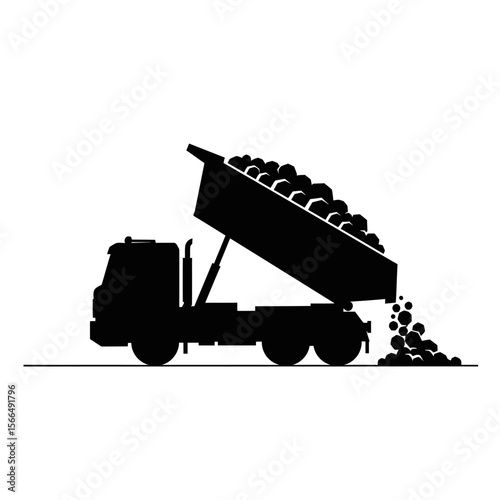 Silhouette of a dump truck unloading cargo.