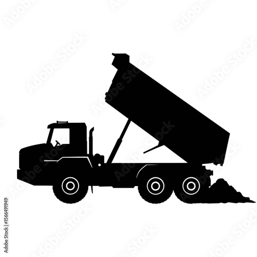 Silhouette of a dump truck unloading its cargo of earth.