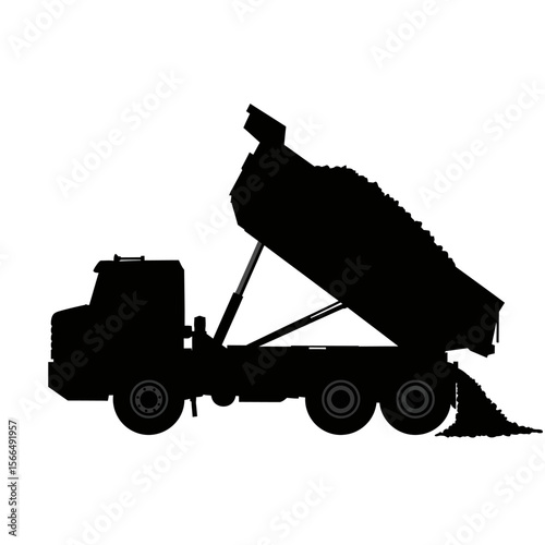Silhouette of a dump truck unloading a load of materials.