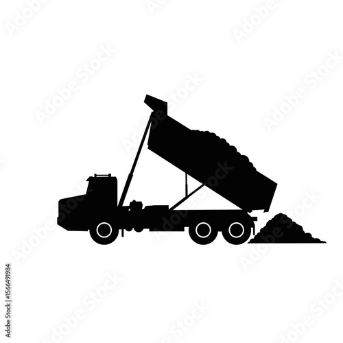 Silhouette of a dump truck unloading materials.
