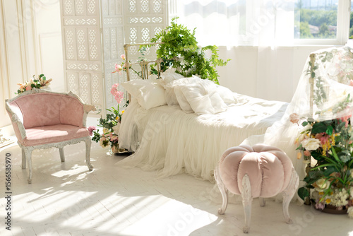 Fototapeta luxury delicate vintage white bedroom with metal bed and pillows and linen in classic style