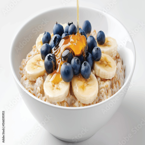 Delight in a flavorful oatmeal bowl, featuring ripe bananas, succulent blueberries, and a drizzle of sweet honey for a nutritious breakfast.