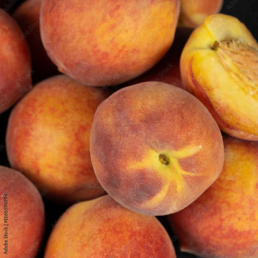 A pile of ripe fresh whole peaches close-up A pile of ripe fresh whole peaches close-up