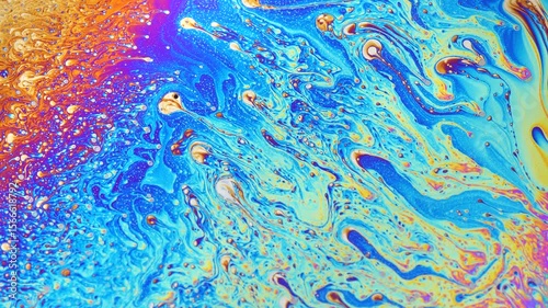 Macro photo of vibrant soap bubble texture with swirling rainbow hues and fluid abstract patterns in bright iridescent tones