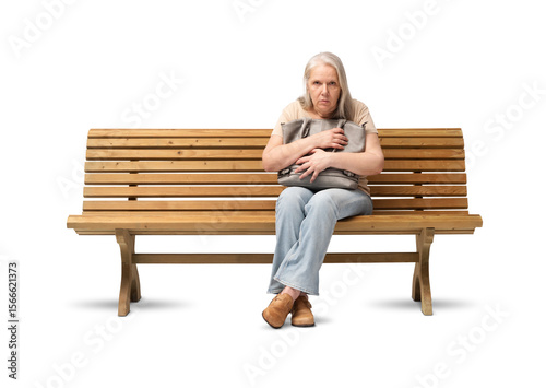 Scared mature woman sitting on a wooden bench, clutching her handbag tightly with a fearful expression. Concept of insecurity, anxiety, or fear of robbery. Isolated on white background