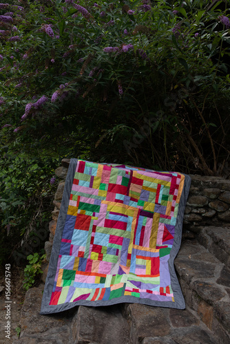 colorful quilt on stone steps