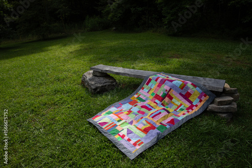 colorful quilt in grassy park