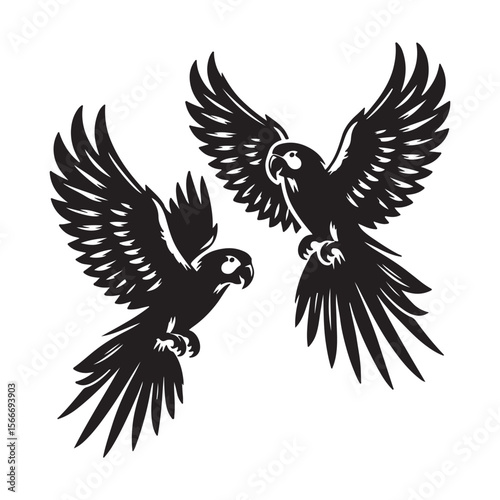 Two black silhouette macaw parrots flying with wings spread wide