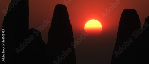 Stunning sunset casts warm glow over jagged mountain peaks, creating dramatic silhouette against vibrant sky
