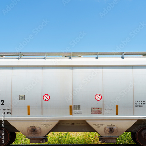 Bild auf Leinwand Hopper car with two No Hammer signs sits idle in a rail siding on a sunny Texas summer afternoon