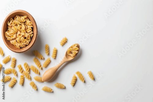 Wooden spoon with uncooked tortiglioni pasta on white background