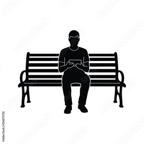 Silhouette of a man sitting on a park bench using a tablet relaxing outdoors