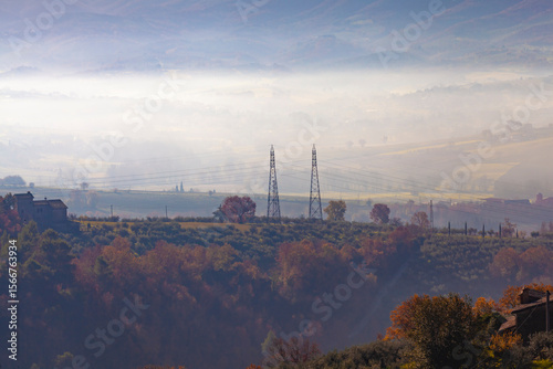 Gualdo Cattaneo Country Misty morning in rural countryside with warm autumn colors and isolated houses