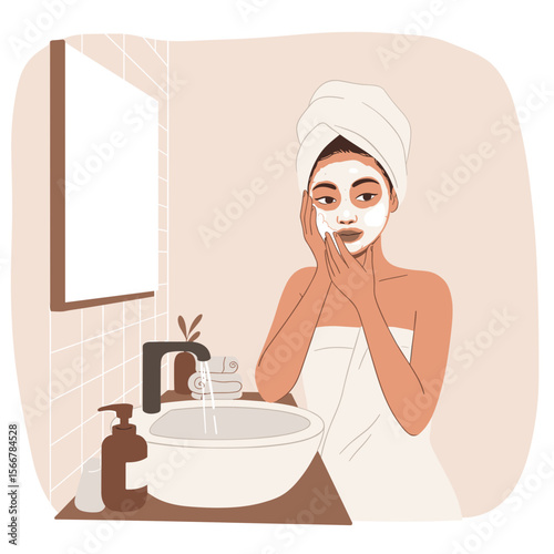 Young woman applying face wash foam while standing at bathroom sink