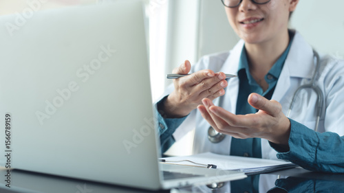Fotografie Doctor using laptop computer online video call, telemedicine to patient, prescribe medicine