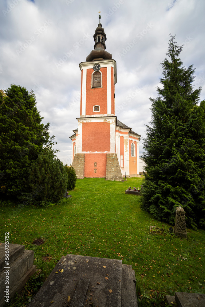 Naklejka premium Church of Saint Procopius standing in Bozanov, Czechia, with cemetery in foreground