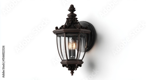 Ornate dark metal outdoor wall lantern with clear glass. Vintage style exterior lighting for warm illumination, enhancing home architecture with elegant charm.