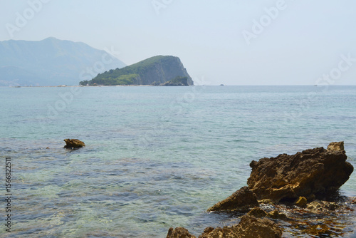 Idyllic Sveti Nikola Island (Hawaii Beach) in Budva, Montenegro, with Swimmers and Mountain Backdrop