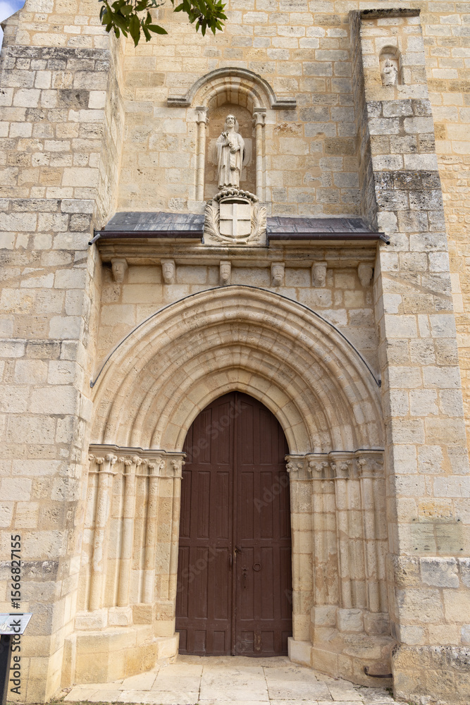 Fototapeta premium Saint Pierre abbey church entrance showing statue and coat of arms in La Sauve, France