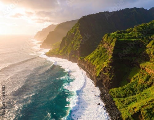 Rugged green cliffs meet the ocean as the sun sets