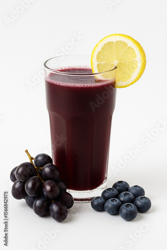 Wallpaper Mural Refreshing Grape and Blueberry Juice: A tall glass of vibrant purple grape and blueberry juice, garnished with a lemon slice, sits beside a bunch of grapes and blueberries. Torontodigital.ca
