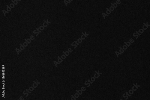 Black matte paper texture background with soft grain. Ideal for dark theme design, luxury branding, minimal presentations, or dramatic contrast compositions.