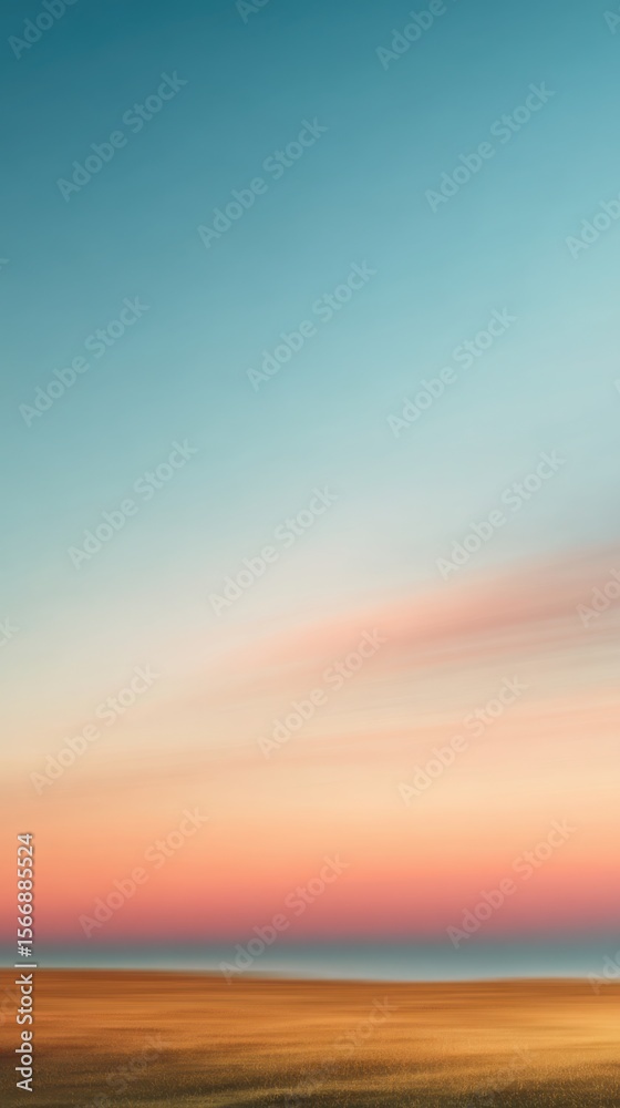 Fototapeta premium A serene landscape featuring a beach at sunset with a gradient sky of blue and orange hues