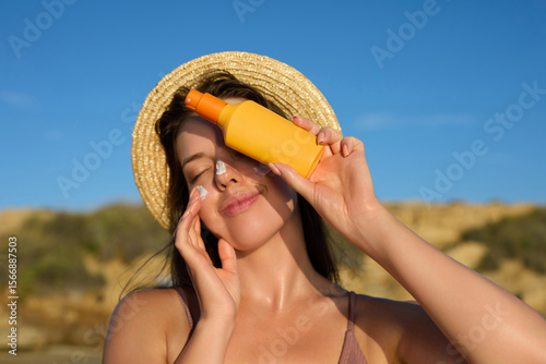 Photos Beautiful Woman in Bikini Applying Sunscreen on Tanned Face