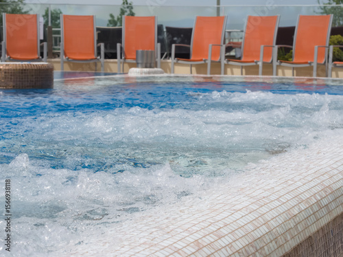 Bubbling Hot Tub with Lounge Chairs